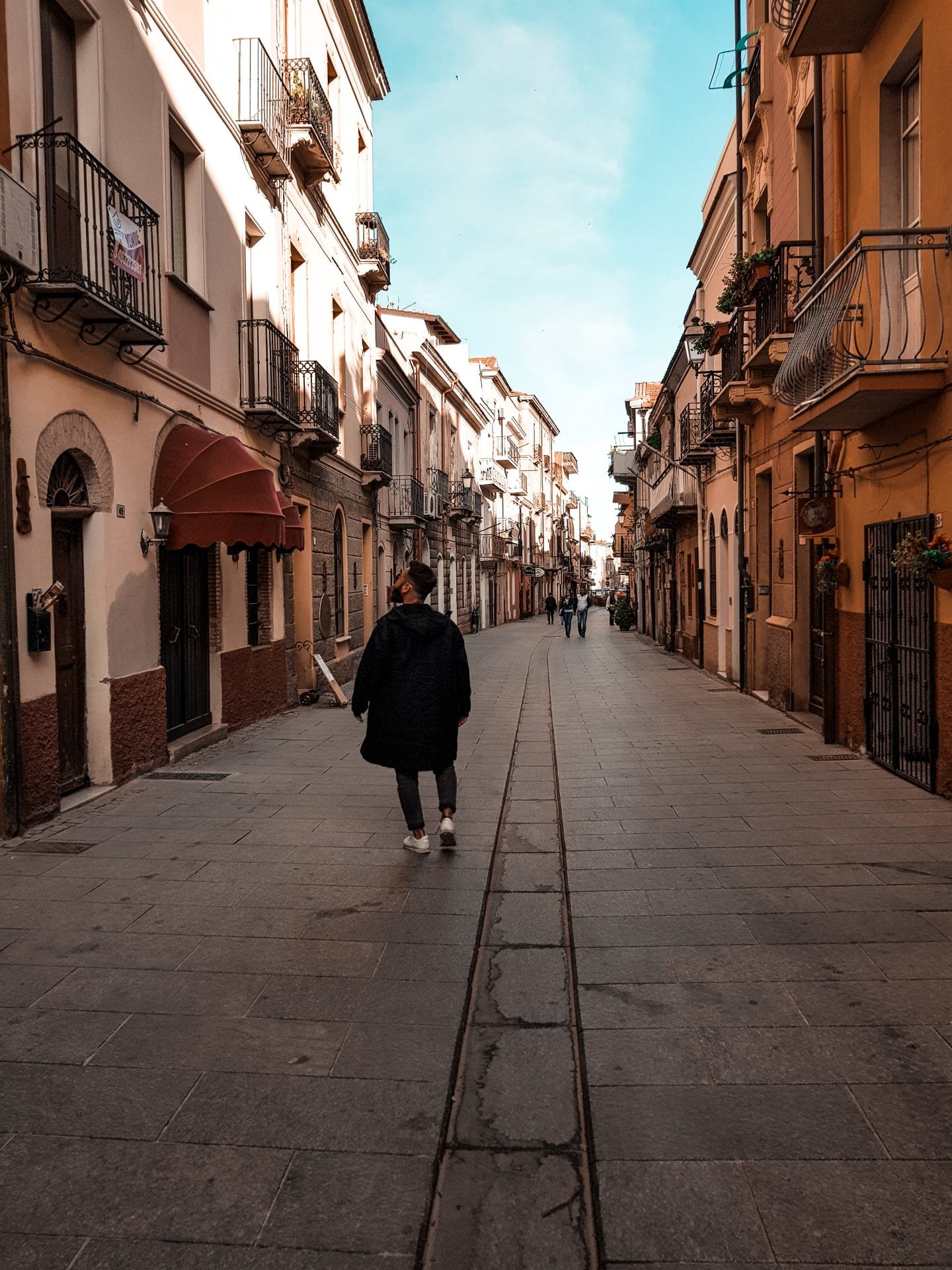guy walking through small italian city