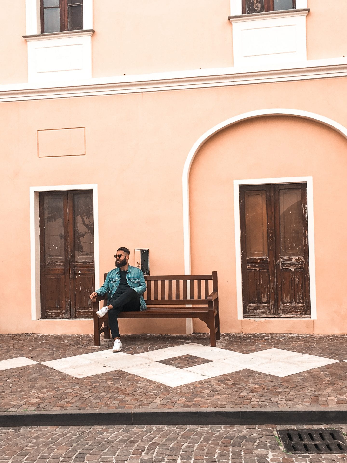 boy sitting in front of italian house