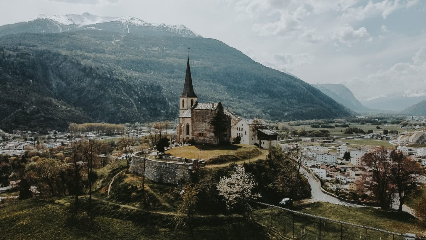 church on a hill in raron swiss alps